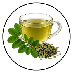 A clear glass cup filled with pale yellow herbal tea, shown with green leaves and a small pile of loose green tea leaves on a white background inside a circular frame.